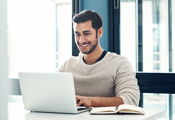 smiling man with computer